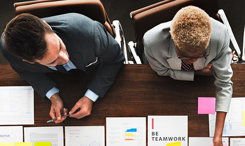 Aerial view of people working at a desk.